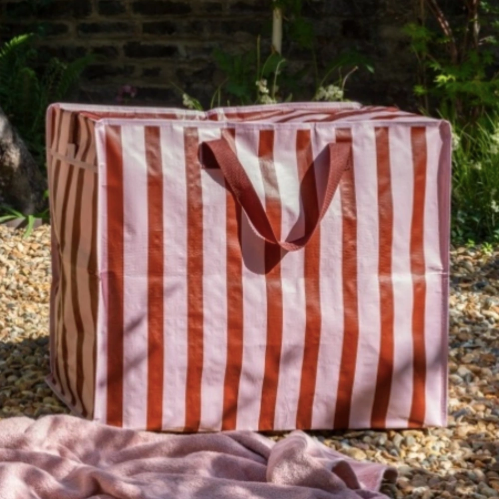 Pink and Brown Jumbo Storage Bag with Nylon handles in an outdoor setting