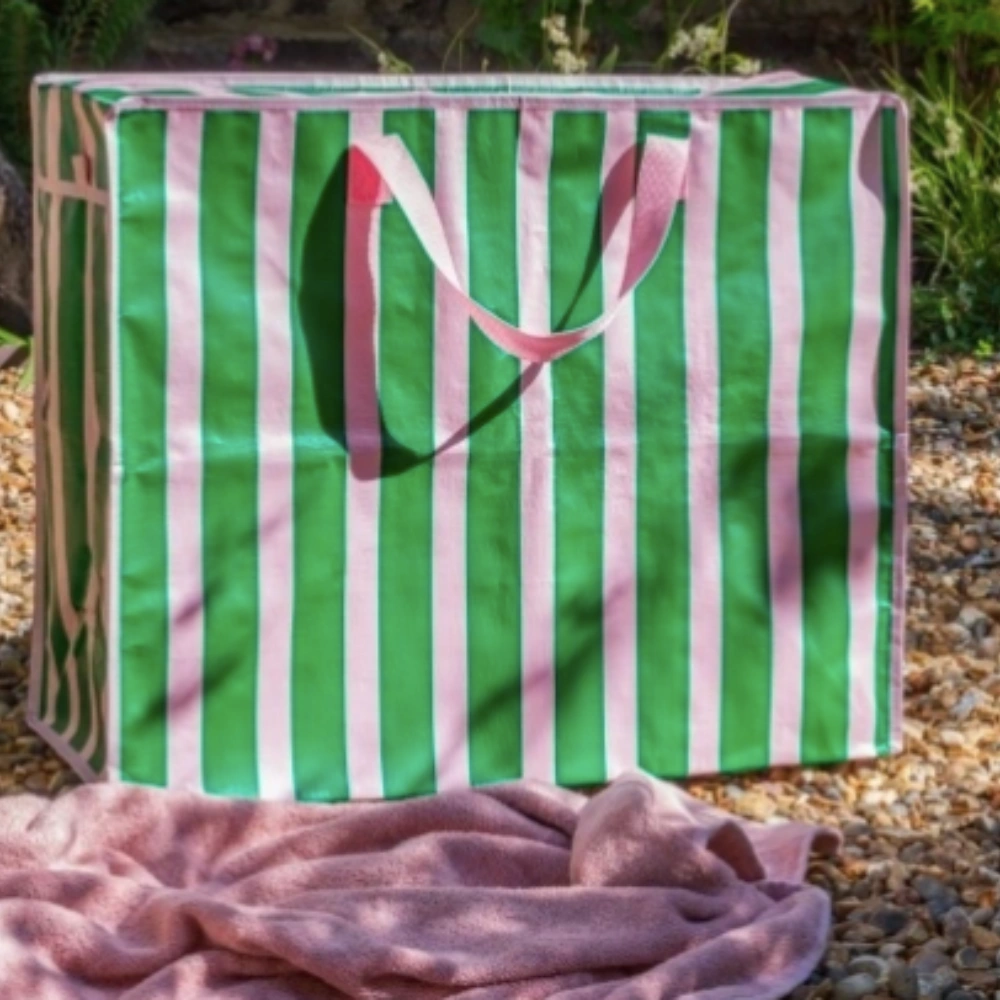 Pink and Green Jumbo Storage Bag with pink handles in an outdoor setting