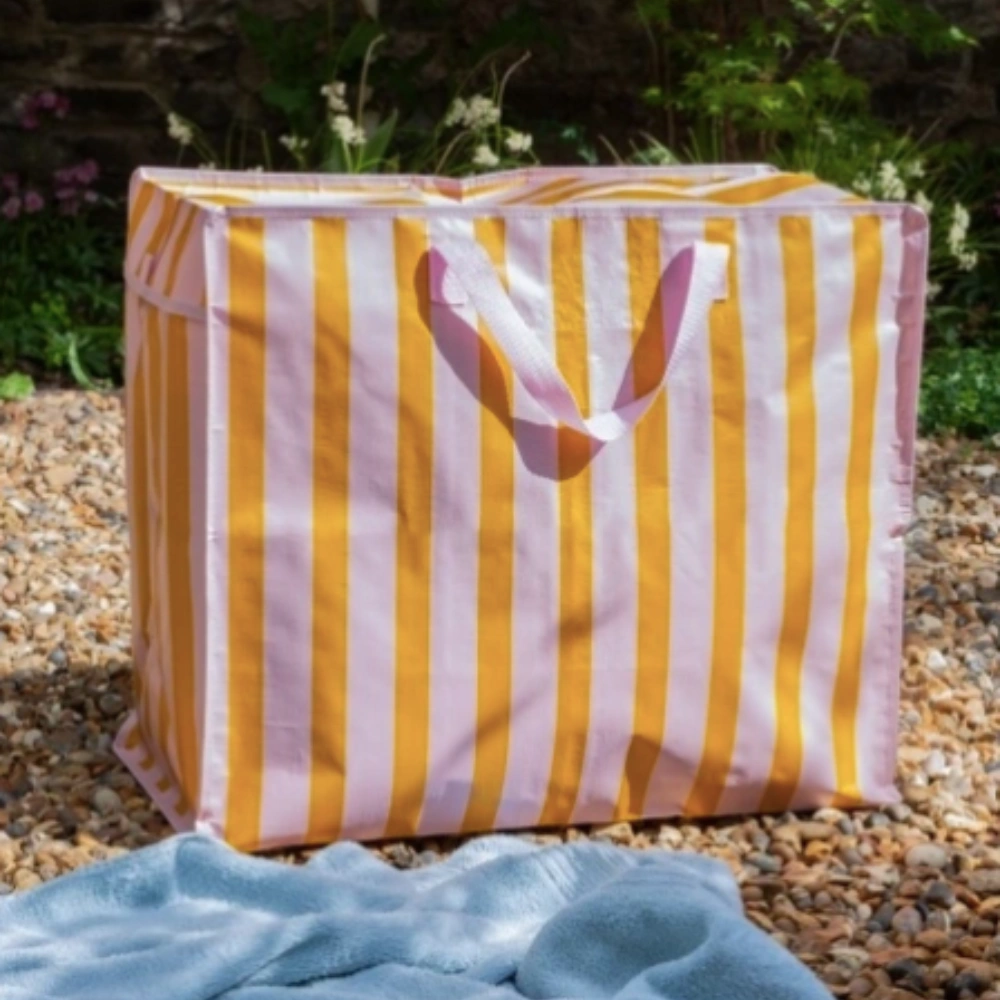 Pink and Orange Jumbo Storage Bag with pink handles in an outdoor setting